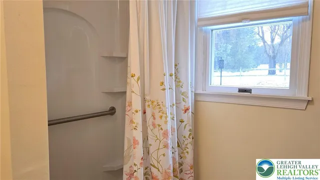 an empty room with windows and entrance