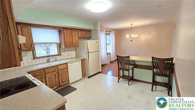 a kitchen with a refrigerator sink and cabinets