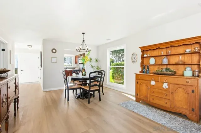 a dining room with furniture and wooden floor
