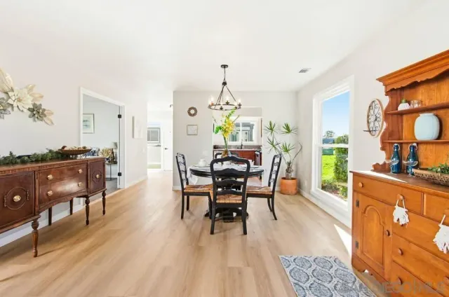 a dining room with furniture a rug and a chandelier