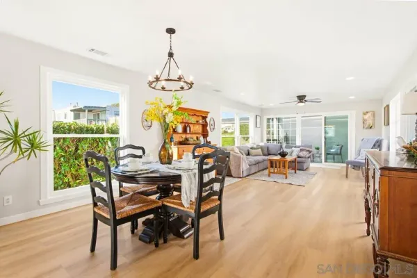 a view of a dining room with furniture and chandelier