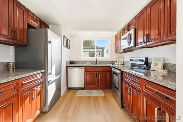 a kitchen with stainless steel appliances a stove a microwave and cabinets