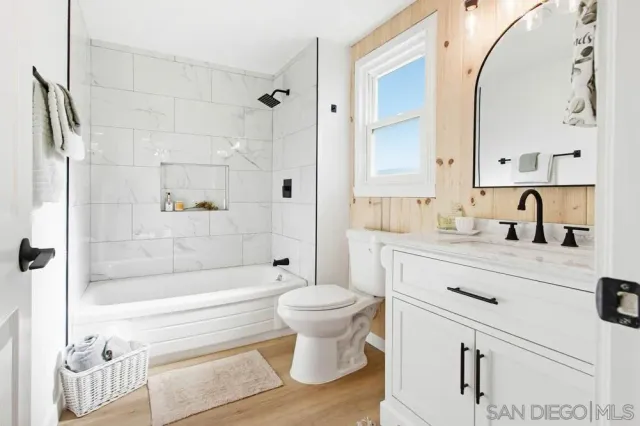 a bathroom with a double vanity sink mirror and shower