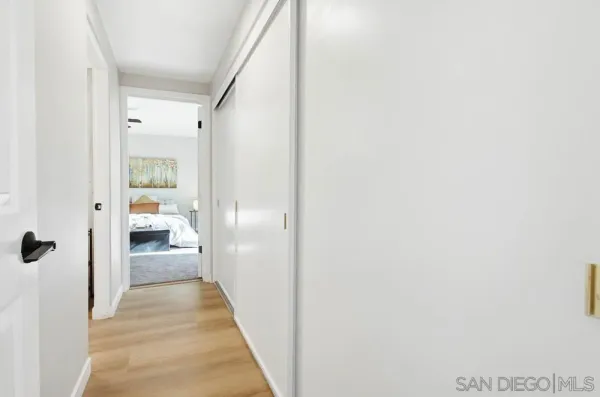 a spacious bedroom with a large bed and a chandelier