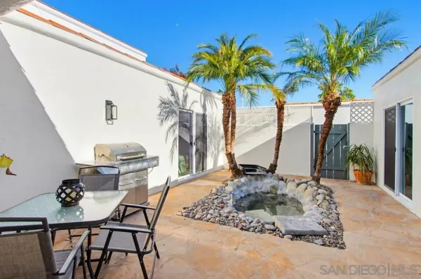 a view of a backyard with a garden and deck