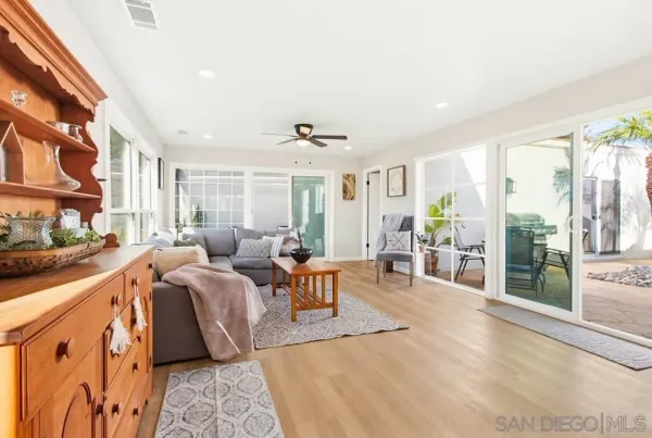 a living room with furniture wooden floor and window