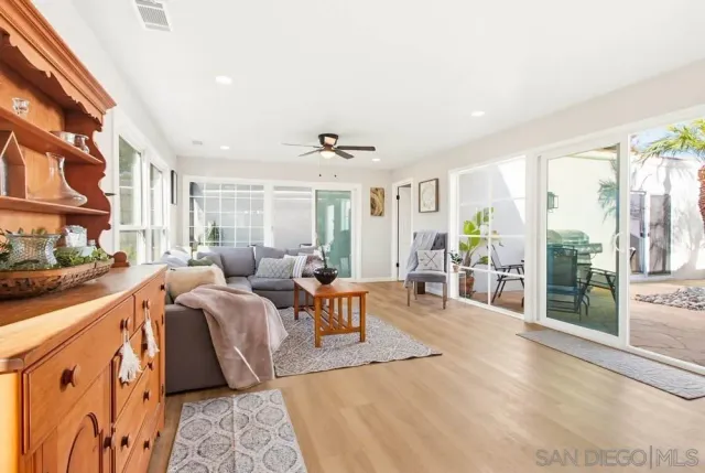 a living room with furniture wooden floor and window