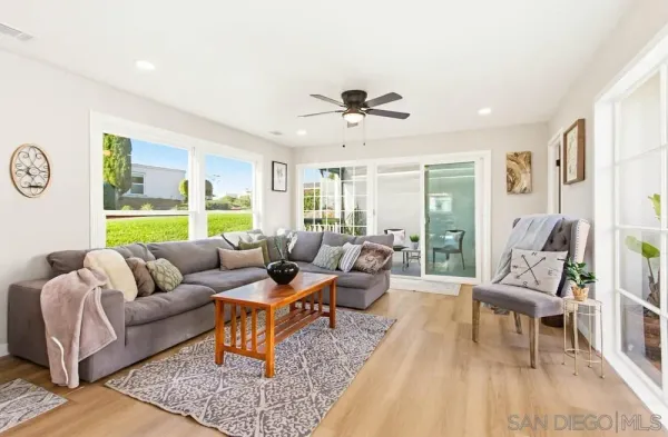 a living room with furniture and a wooden floor