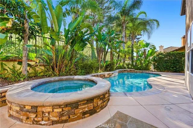 a spacious bedroom with a bed and glass window