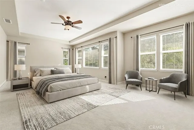 an empty room with wooden floor chandelier fan and windows