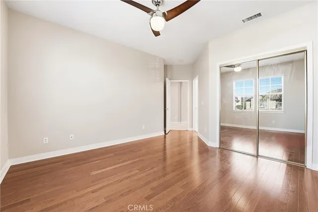 a view of a house with a wooden fence