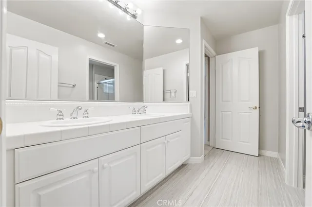 a view of a pathway with a wrought fence