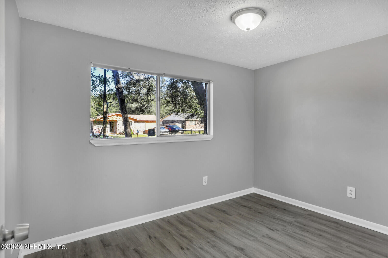 4444 Crossbow Road Jacksonville, FL 32208 - Photo 8 of 15 an empty room with wooden floor and a window