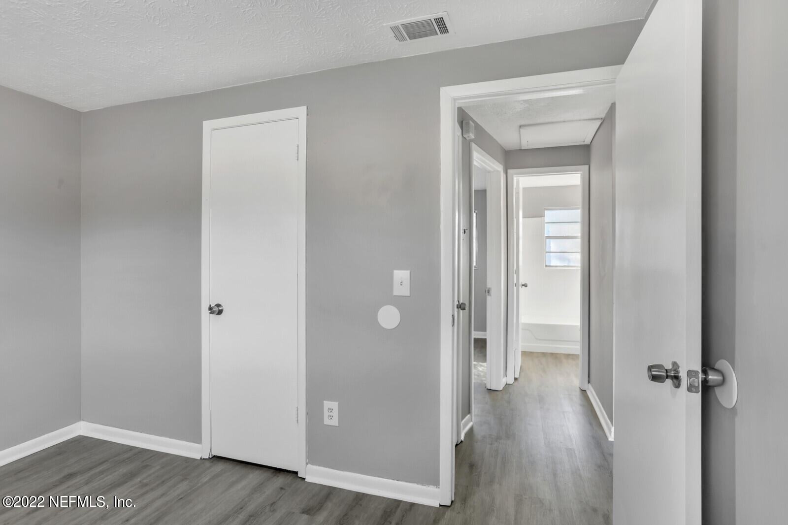 4444 Crossbow Road Jacksonville, FL 32208 - Photo 10 of 15 a view of a hallway with wooden floor