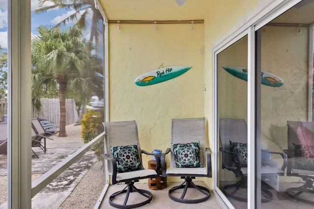 a view of a chairs and table in patio