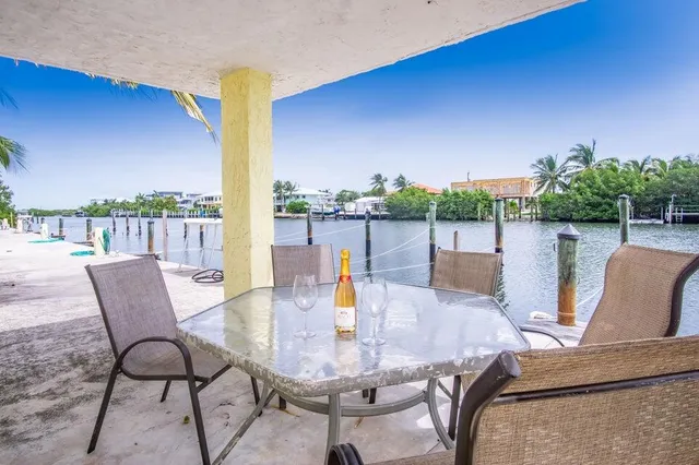 a view of a swimming pool with a patio and a yard