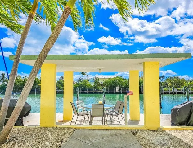 a view of a patio with a table chairs and a fire pit