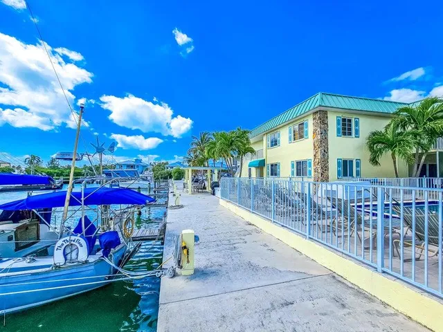 a view of a lake with lawn chairs