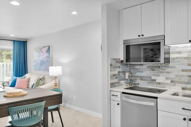 a kitchen with a table chairs and refrigerator