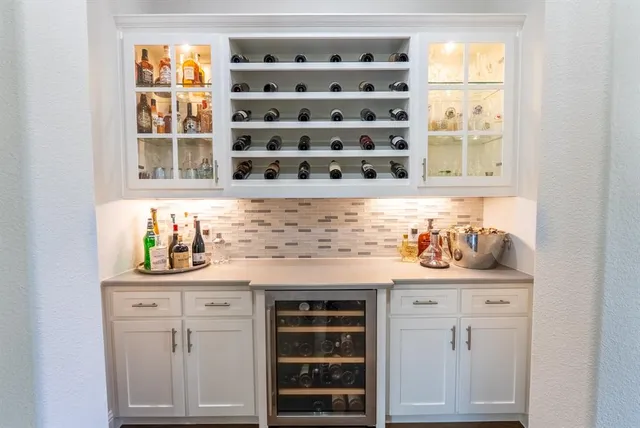 a kitchen with a sink a counter space appliances and cabinets