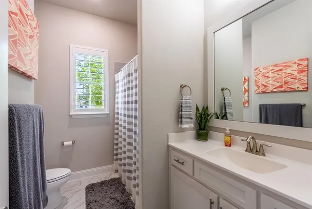 a living room with furniture a dining table and a chandelier