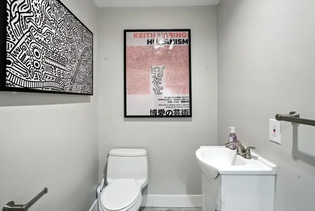 a white toilet sitting next to a bathroom sink