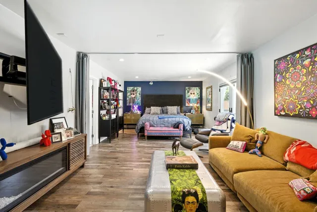 a view of a backyard with table and chairs and a large tree