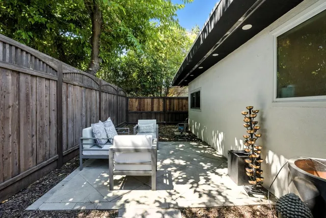 a view of a house with backyard tub and sitting area