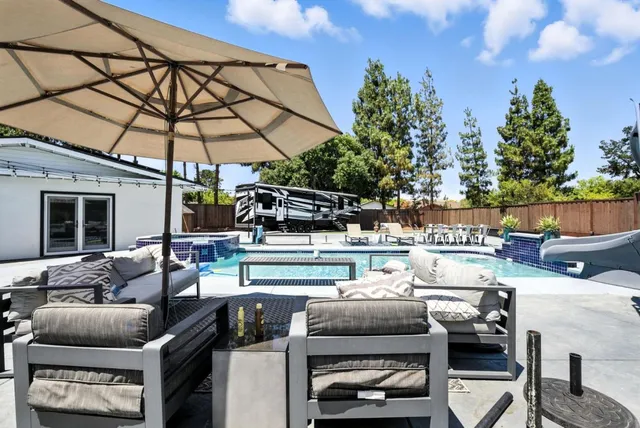 a view of a backyard with sitting area