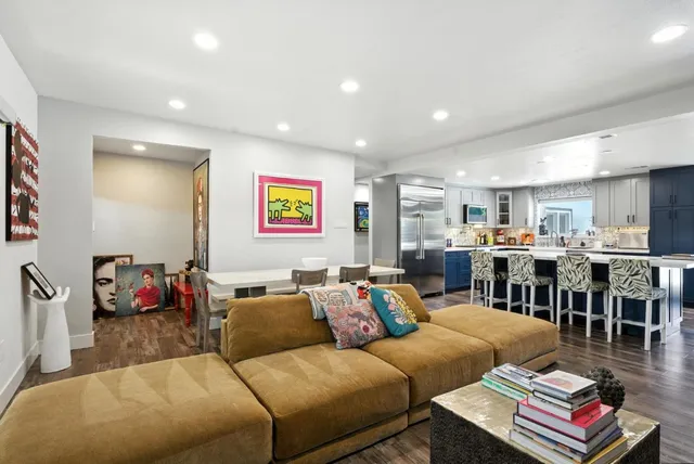 a living room with furniture kitchen view and a table