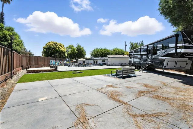 an aerial view of a house with a garden and trees
