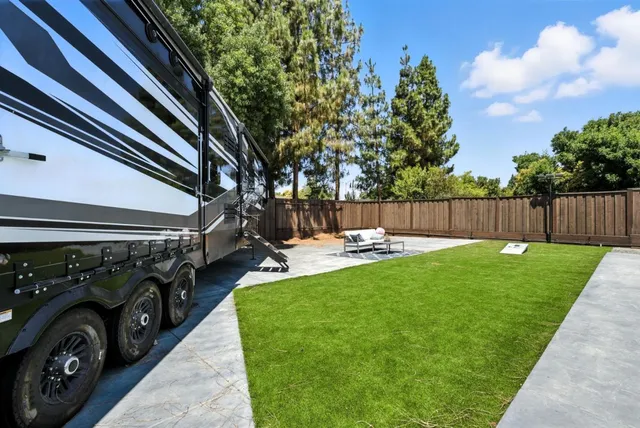 an aerial view of a house with garden space and sitting area