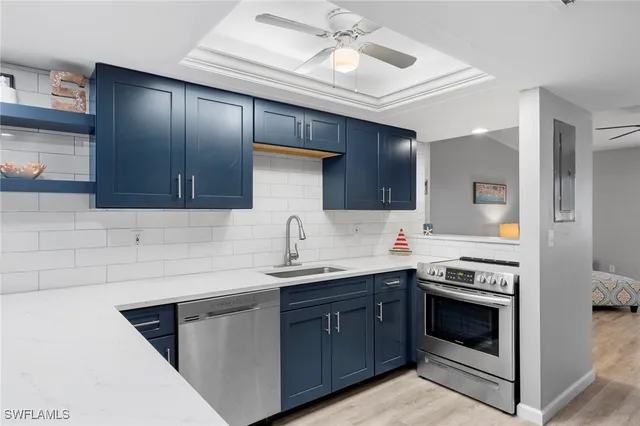 a kitchen with stainless steel appliances kitchen island a refrigerator sink and cabinets