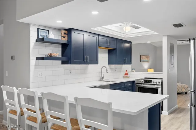 a kitchen with a sink stove and cabinets
