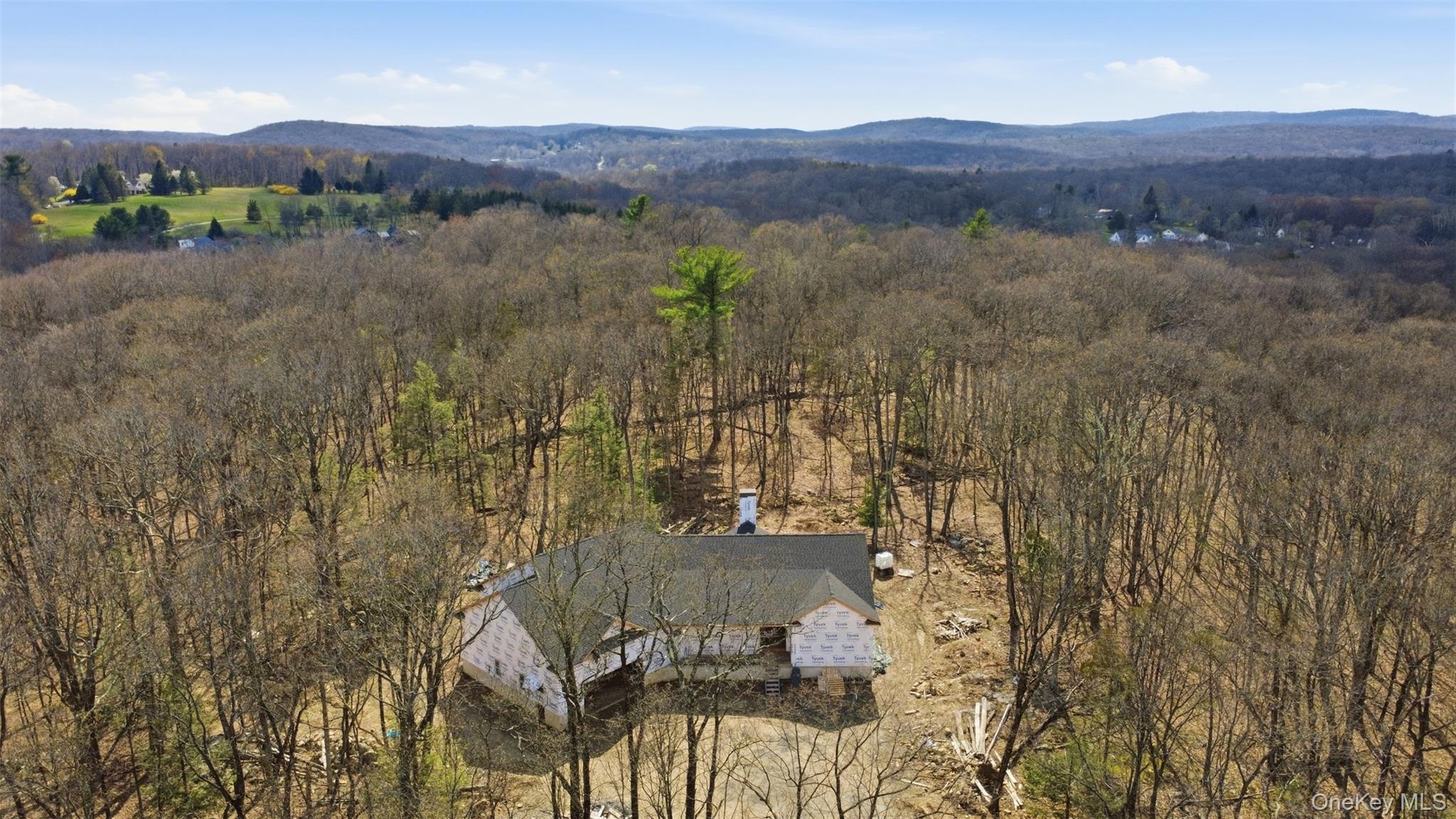 an aerial view of residential house and sandy dunes