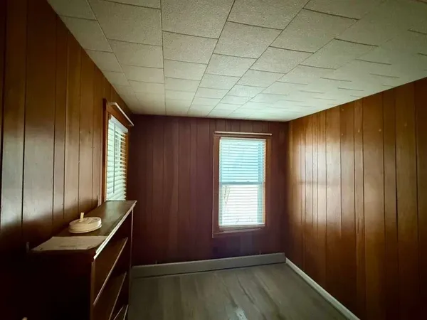 a view of hallway with furniture and wooden floor