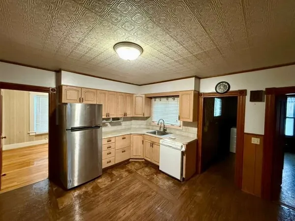 a kitchen with a refrigerator and a sink