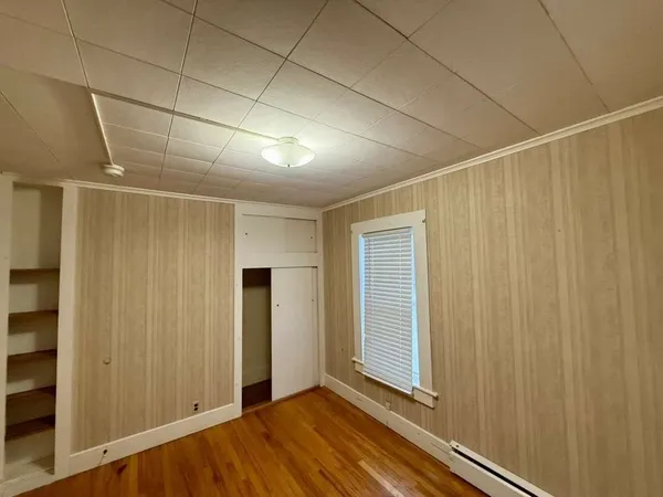 a view of a room with wooden floor