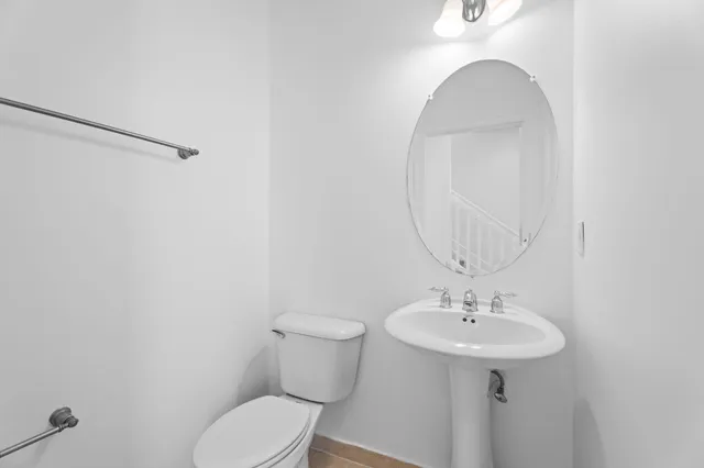 a view of an empty room with windows and chandelier