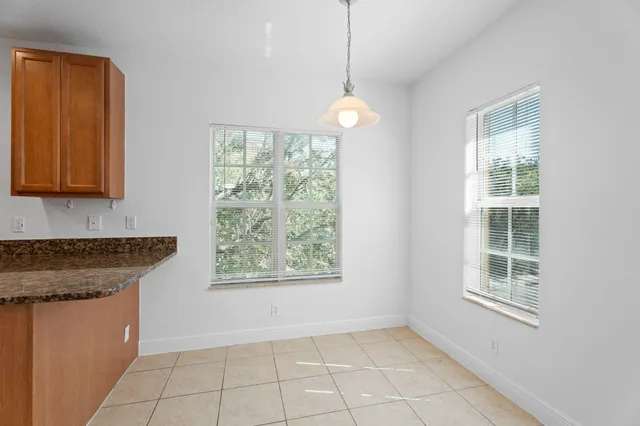 a kitchen with stainless steel appliances granite countertop a stove top oven a sink dishwasher a refrigerator and a microwave