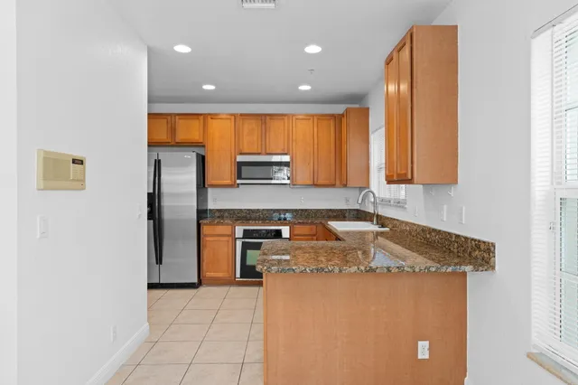 a kitchen with stainless steel appliances a refrigerator and a stove top oven