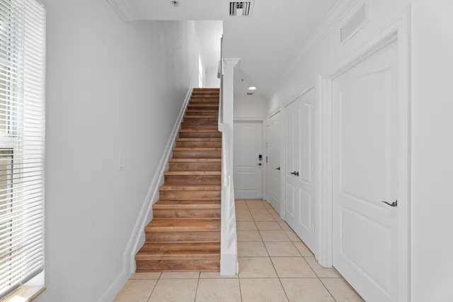 a view of entryway and hall with wooden floor