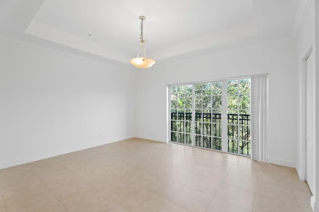 a view of a room with an entryway and chandelier