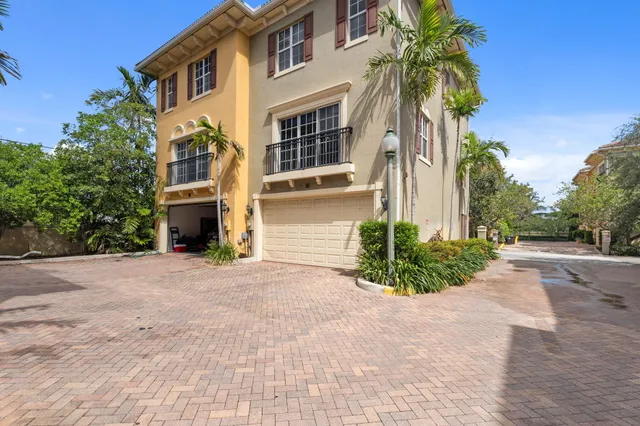 a front view of a house with swimming pool and sitting area