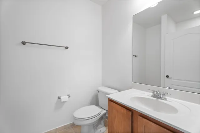 a bathroom with a granite countertop sink toilet and a mirror