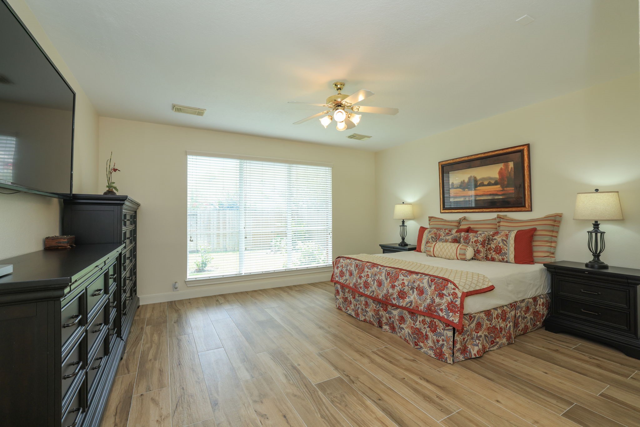 3711 Sapling Trail Court Spring, TX 77388 - Photo 21 of 50 a bedroom with a large bed a chandelier and windows