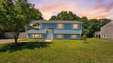 a front view of a house with a yard