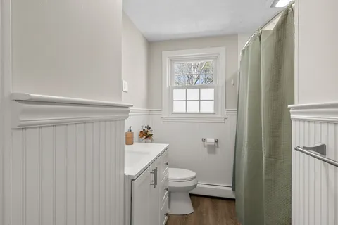 a bathroom with a toilet a sink and tub