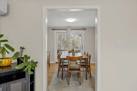 a dining room with furniture and a potted plant
