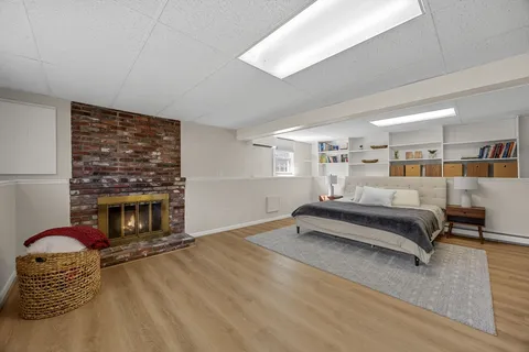 a bedroom with furniture and a fireplace
